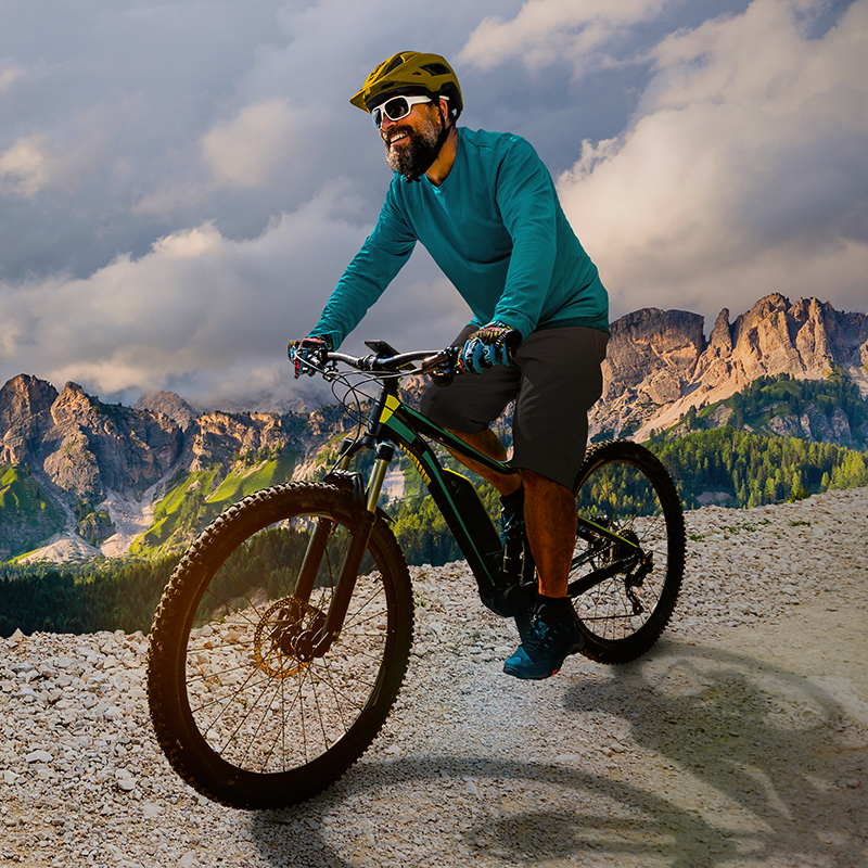 Man riding a mountain bike on a mountain bluff.