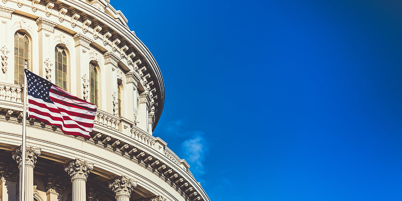 Ornate building with American flag flying in front of it.