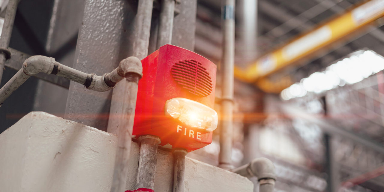 Fire alarm on pole in warehouse.