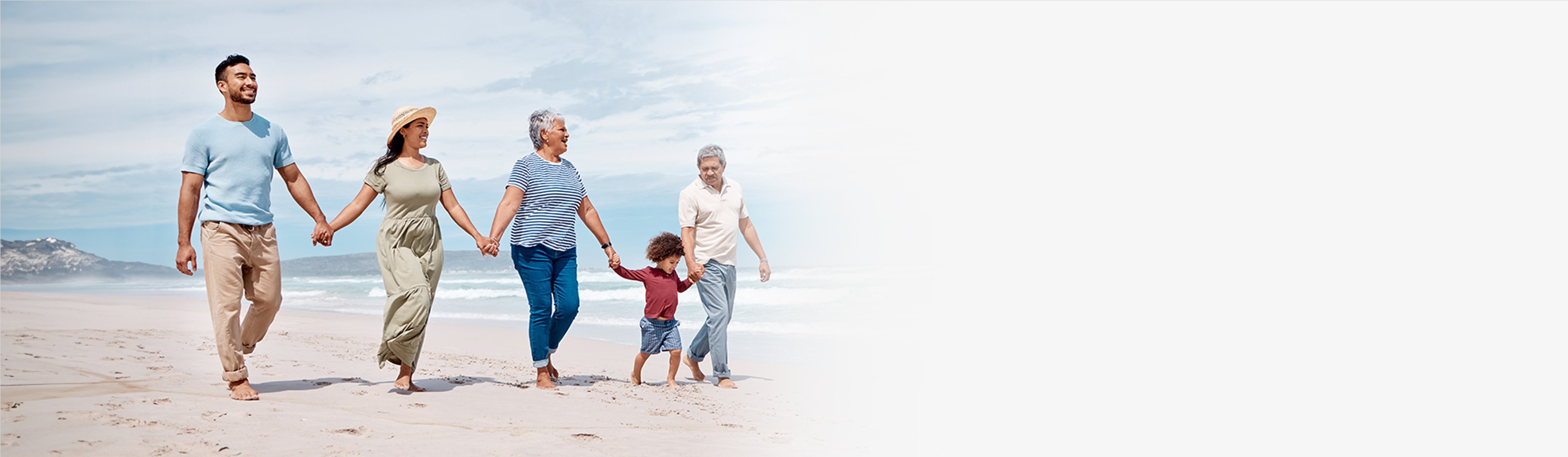Multi-generational family walking on a beach