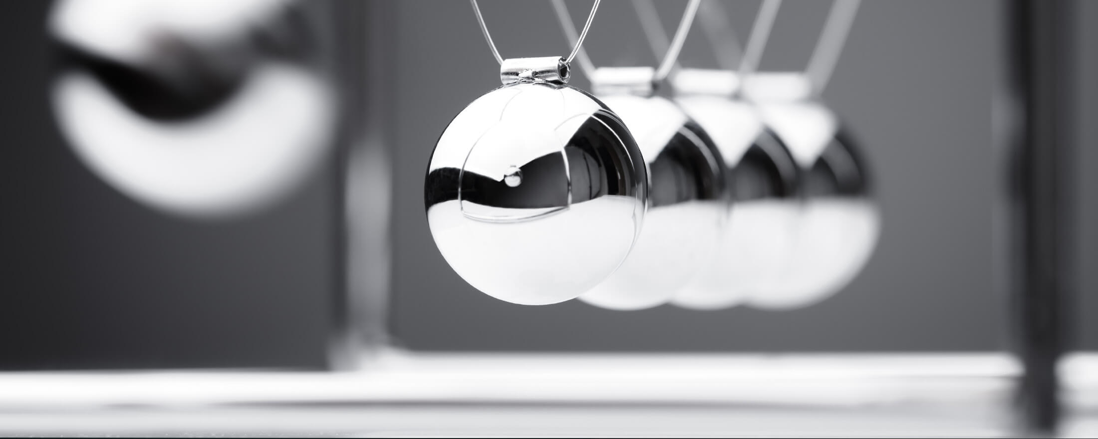 Black and white closeup of a Newton's Cradle