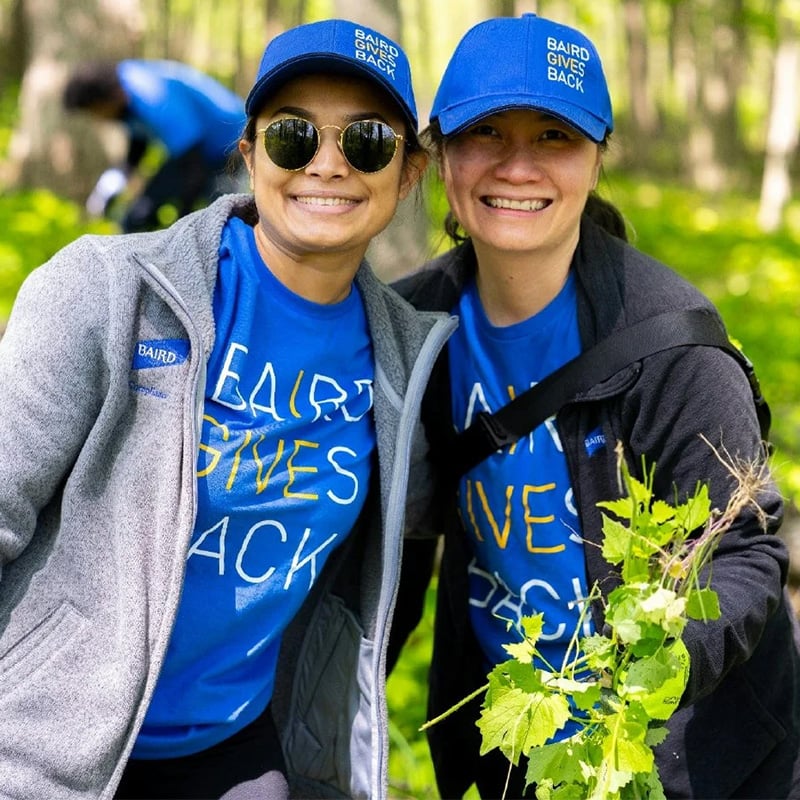 Two Baird associates volunteering outdoors during in Baird Gives Back apparel