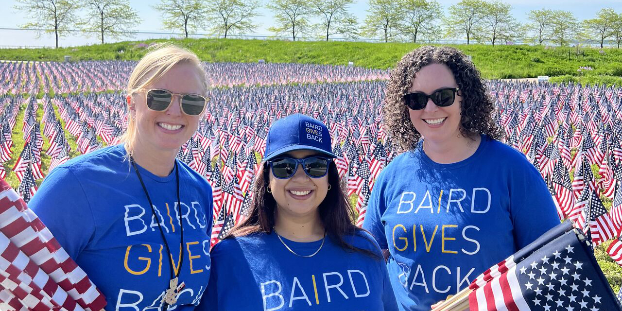 Baird associates planting flags at the Milwaukee War Memorial