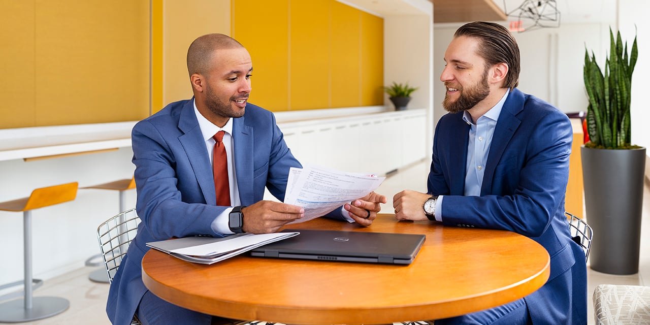 Two businessmen at a conference table.