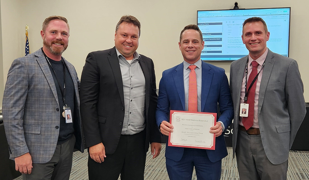Baird’s Wisconsin Public Finance team members holding certificate for the 2025 Wisconsin Association of School Boards (WASB) Business Partner Honor Roll.