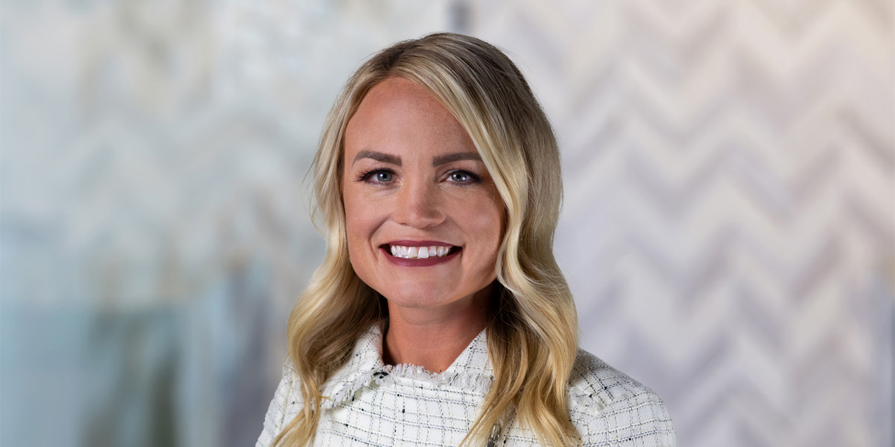 Headshot of Stephanie Warren with a chevron pattern background.