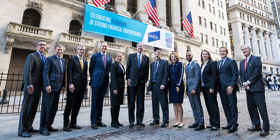 Baird Executive Committee standing in front of the New York Stock Exchange building.