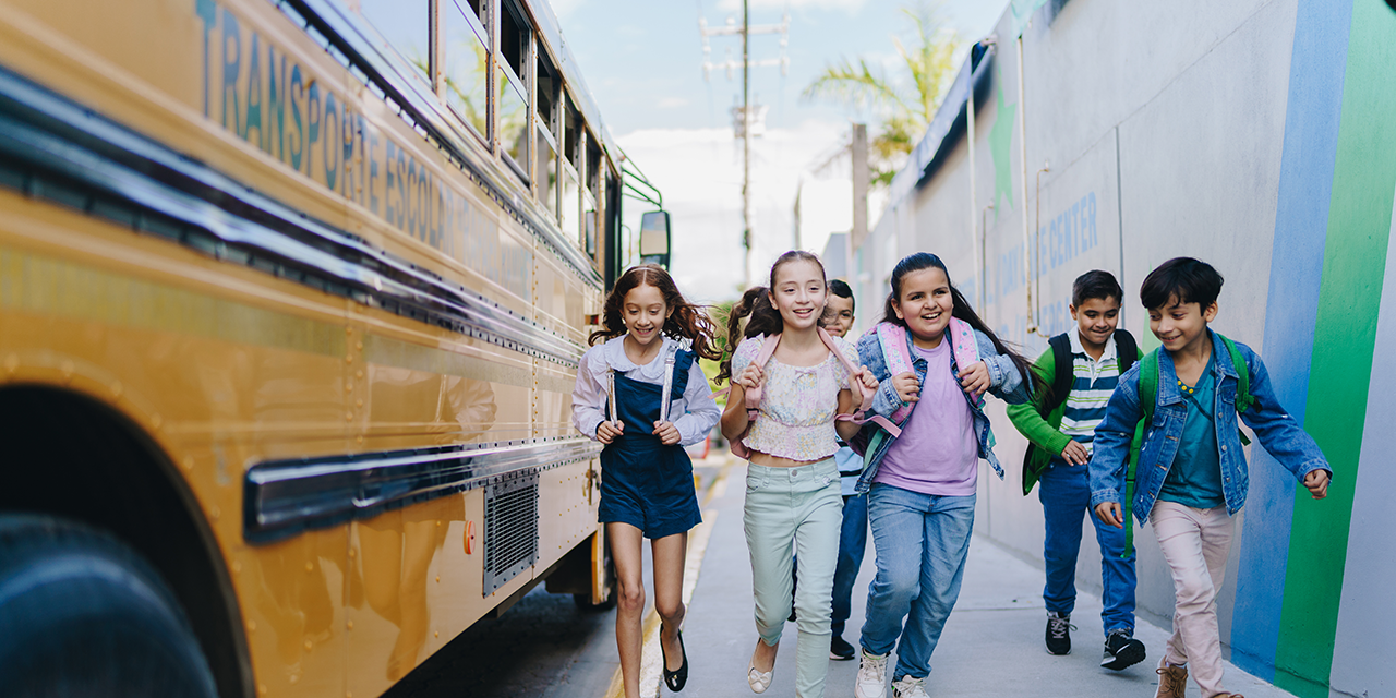 School children walking away from a school bus.