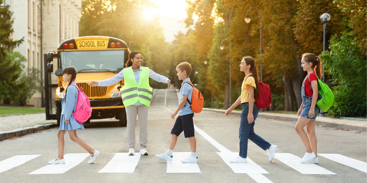 Crossing guard assisting elementary school children as they cross the street