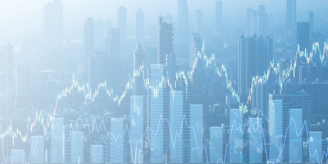 City skyline with financial graphs overlaid on image