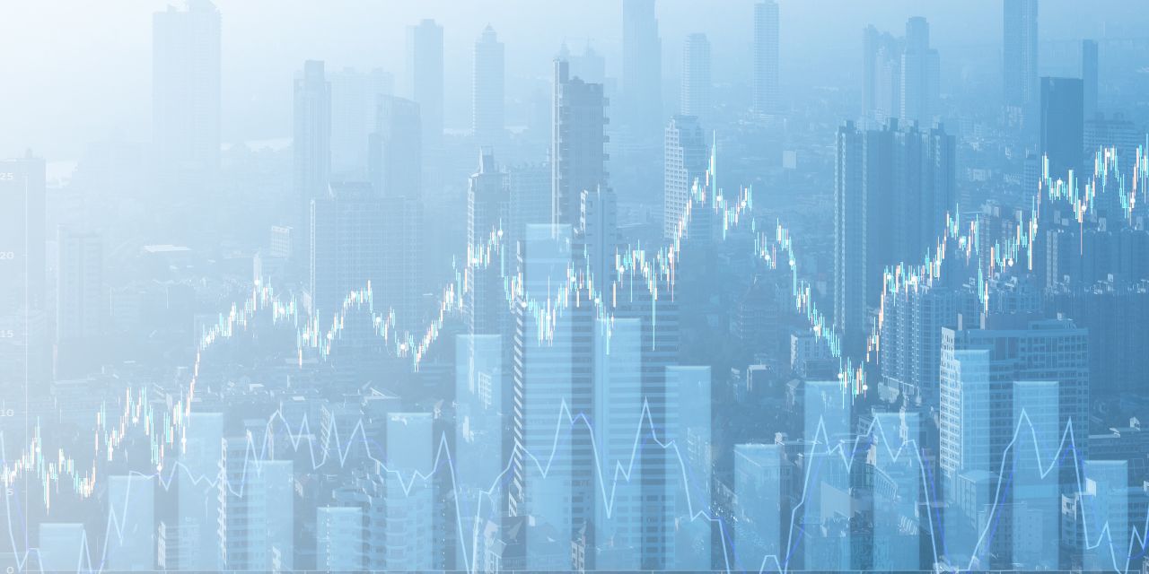 City skyline with financial graphs overlaid on image