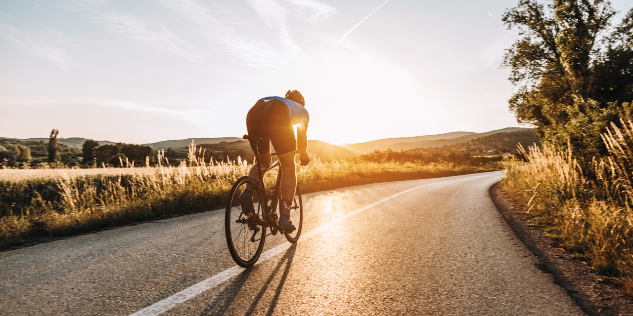 Bicycle rider on rural road.