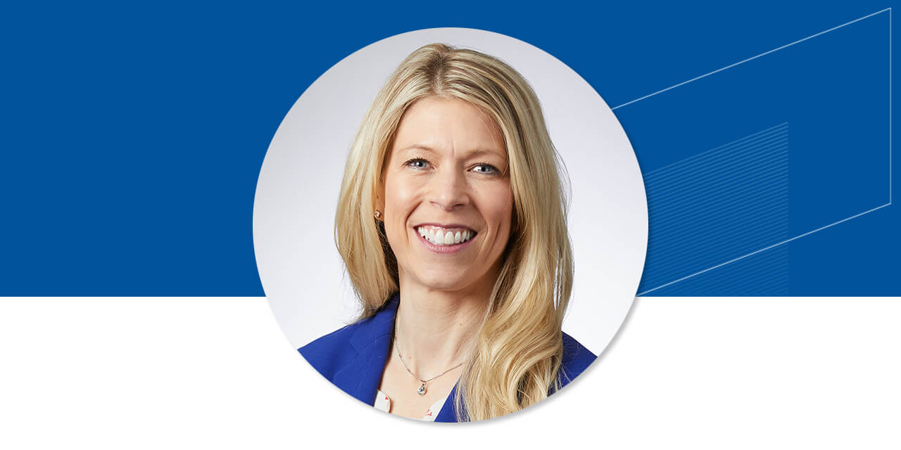 Headshot of Jeannette Haen on a blue background with an abstract Baird logo