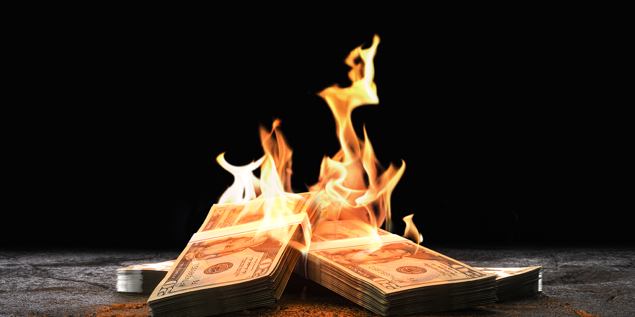 Closeup heap of burning dollar bills.