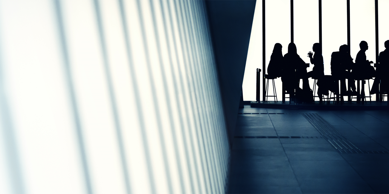 Silhouette images of people in a meeting.