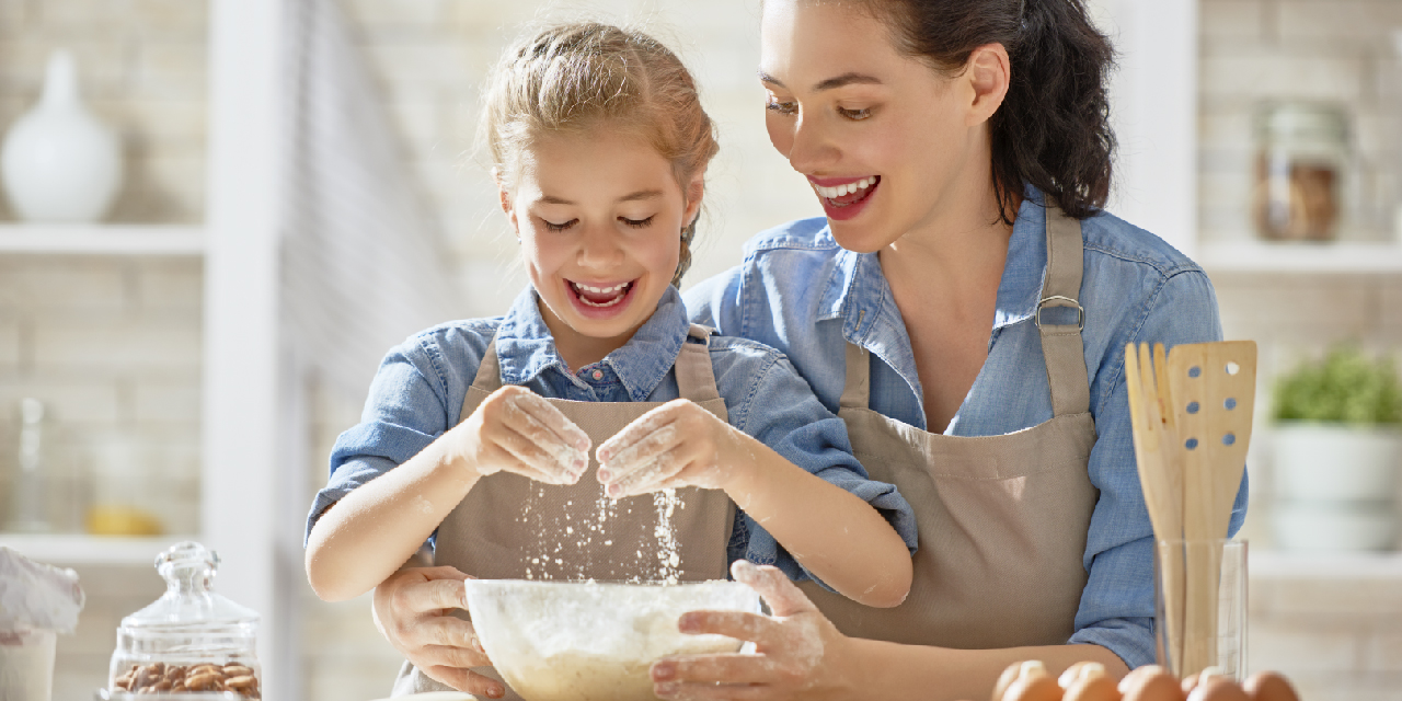 Adult and child baking in kitchen